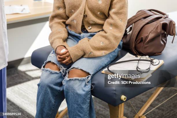 unrecognizeable female patient sits in the doctor's office for her medical exam - prozac stock pictures, royalty-free photos & images