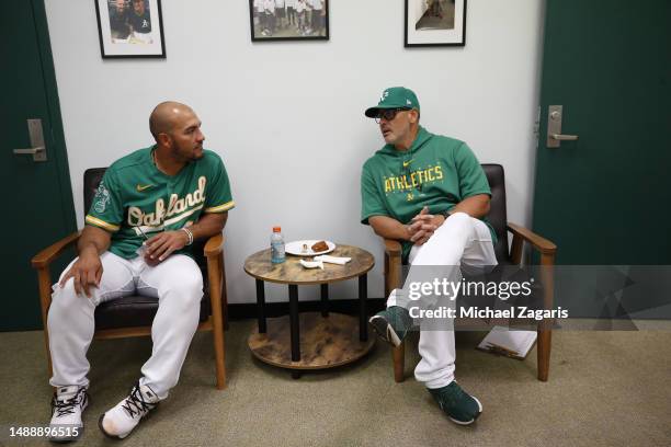 Carlos Perez and Major League Staff Assistant Ramon Hernandez of the Oakland Athletics in the clubhouse before the game against the Cincinnati Reds...