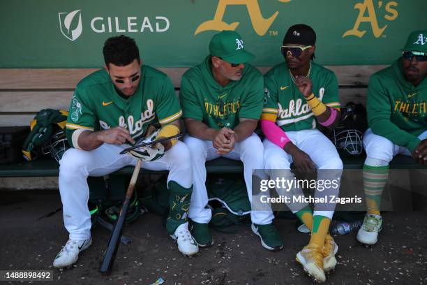 Ramon Laureano, Major League Staff Assistant Ramon Hernandez and Esteury Ruiz of the Oakland Athletics in the dugout during the game against the...