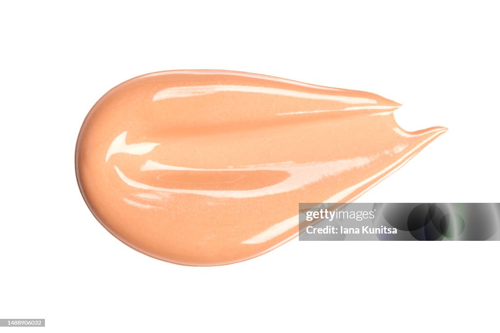 Beautiful delicate pink, beige smear of BB face cream on white background isolated. Tonal Foundation is smudged. Products for makeup and skin care. Organic cosmetics. Cosmetology. Closeup. Skin tone.
