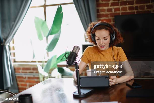 woman doing a solo podcast from her studio in los angeles, california - los angeles press stock pictures, royalty-free photos & images