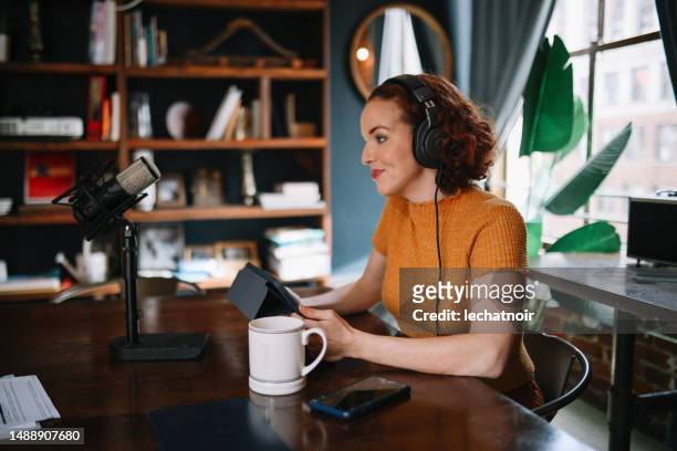 woman doing a solo podcast from her studio in los angeles, california - los angeles press stock pictures, royalty-free photos & images