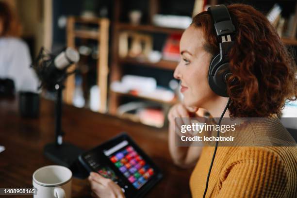 woman doing a solo podcast from her studio in los angeles, california - los angeles press stock pictures, royalty-free photos & images