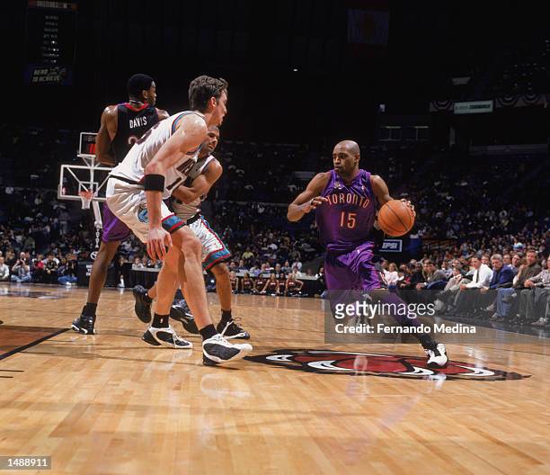 Guard Vince Carter of the Toronto Raptors drives past forward Pau Gasol of the Memphis Grizzlies during the NBA game at the Pyramid Arena in Memphis,...