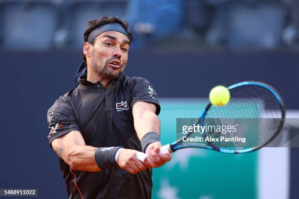 Fabio Fognini of Italy plays a backhand against Andy Murray of Great Britain during the Men's Singles First Round match on Day Three of the...