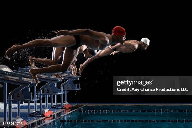 male swimmers at start of a race. - championship stock pictures, royalty-free photos & images