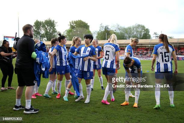 Players of Brighton & Hove Albion hand in their anthem jackets as they prepare to kick off prior to the FA Women's Super League match between...