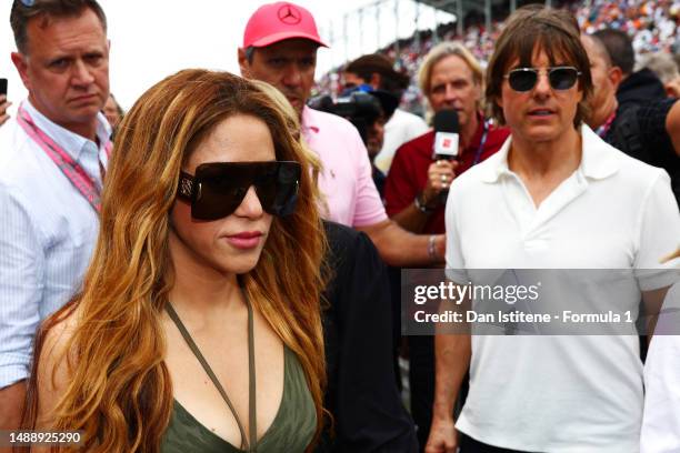 Shakira and Tom Cruise walk on the grid prior to the F1 Grand Prix of Miami at Miami International Autodrome on May 07, 2023 in Miami, Florida.