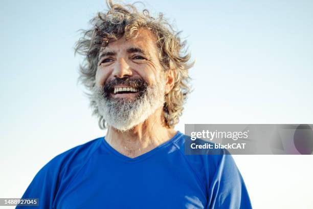 satisfied senior man thinking at beach - satisfied-face stock pictures, royalty-free photos & images