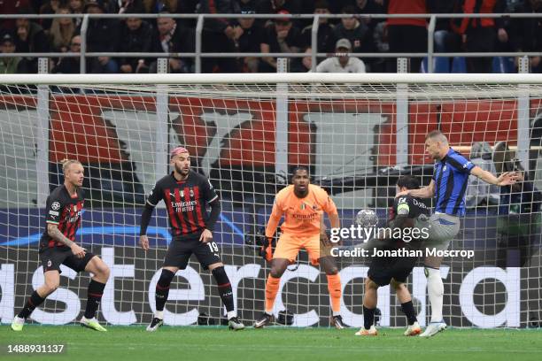 Edin Dzeko of FC Internazionale scores to give the side a 1-0 lead during the UEFA Champions League semi-final first leg match between AC Milan and...