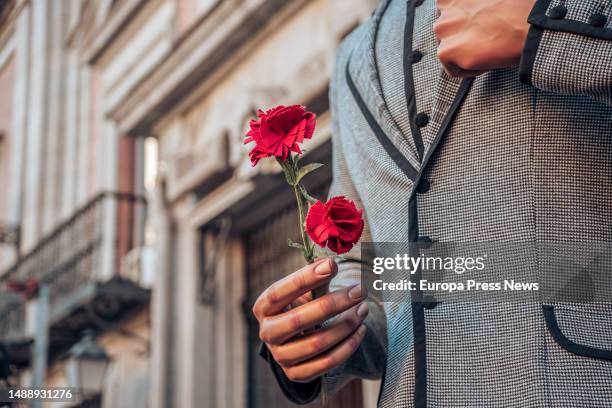 Man dressed as a chulapo with a carnation during the reading of the proclamation of the Fiestas de San Isidro 2023, from the Casa de la Villa, on 10...