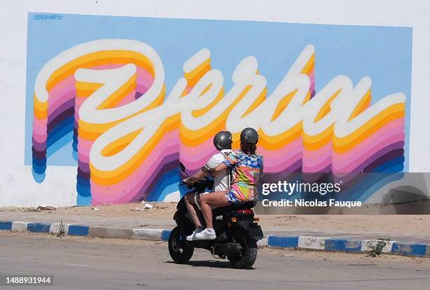 Tow people ride a scooter following a suspected terrorist attack yesterday during a pilgrimage on May 10, 2023 in Djerba, Tunisia. A gun attack...