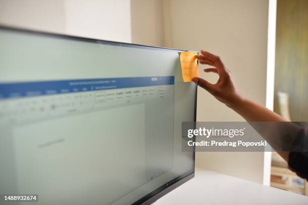 female checking notes on computer - sticky-notes-covering-computer-monitor stock pictures, royalty-free photos & images
