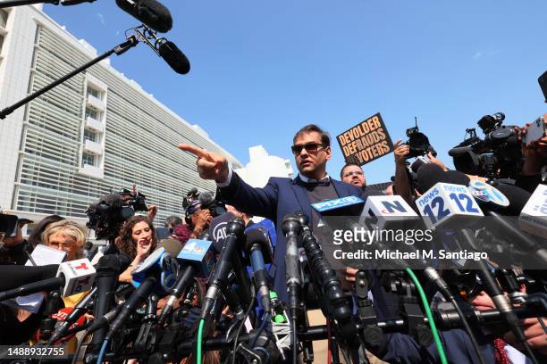 Rep. George Santos speaks with members of the press as he leaves Federal Court on May 10, 2023 in Central Islip, New York. Federal prosecutors in the...