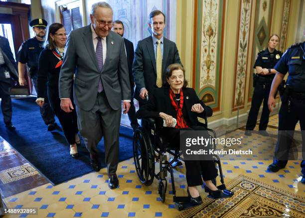 Senate Majority Leader Charles Schumer escorts Sen. Dianne Feinstein as she arrives at the U.S. Capitol following a long absence due to health issues...