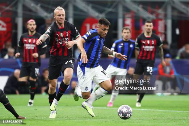 Lautaro Martinez of FC Internazionale is tackled by Simon Kjaer of AC Milan, which results in a VAR Review for a potential Penalty incident, during...