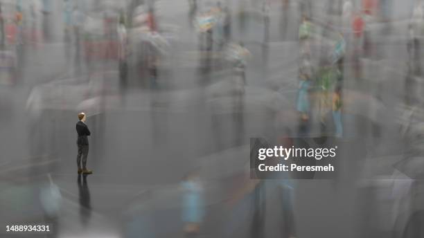 lowpoly man standing in the fast moving crowds of people - oblivious stock pictures, royalty-free photos & images