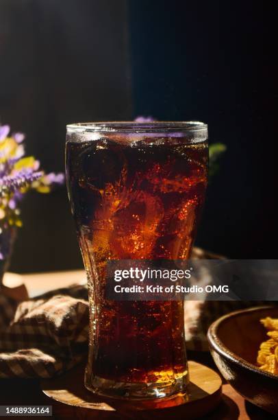 a glass of cola on the table - portion imagens e fotografias de stock