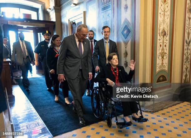 Senate Majority Leader Charles Schumer escorts Sen. Dianne Feinstein as she arrives at the U.S. Capitol following a long absence due to health issues...