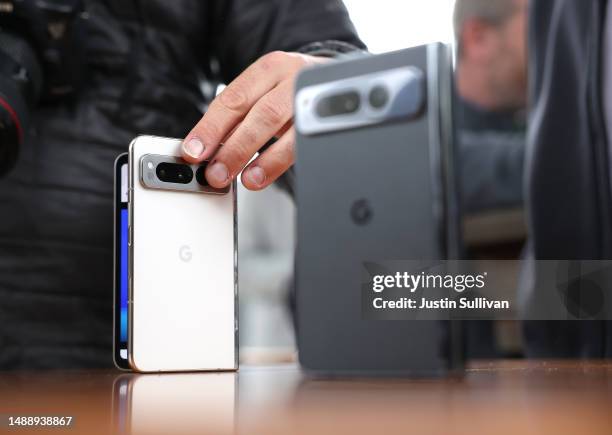 Member of the media inspects the new Google Pixel Fold phone during the Google I/O developers conference at Shoreline Amphitheatre on May 10, 2023 in...