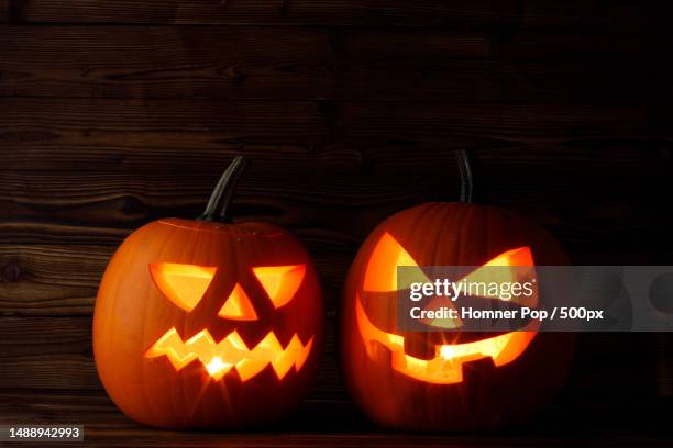 close-up of illuminated jack o lanterns on table,romania - sinful pleasures stock-fotos und bilder