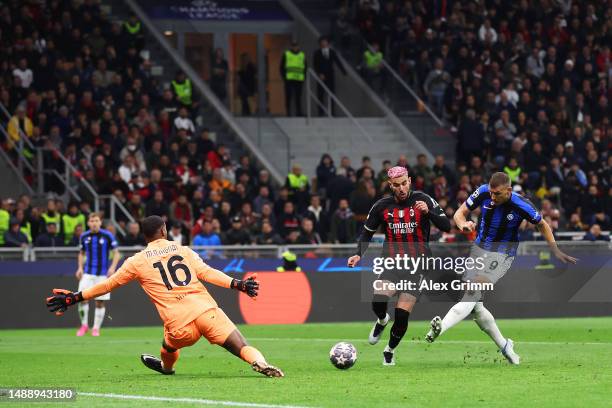 Edin Dzeko of FC Internazionale shoots whilst under pressure from Theo Hernandez of AC Milan as Mike Maignan of AC Milan attempts to make a save...