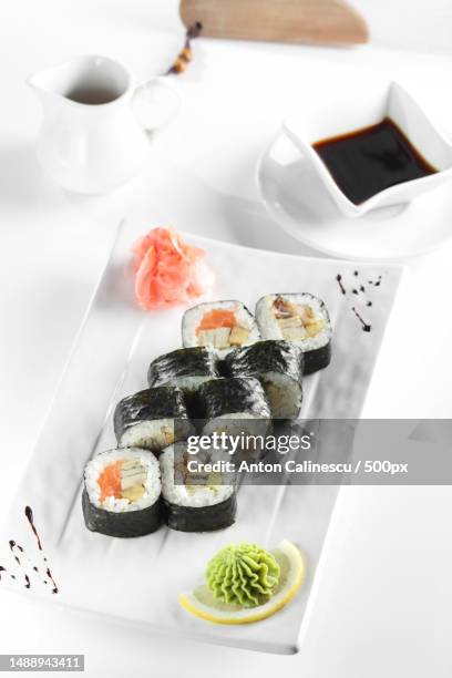 high angle view of sushi served in plate on white background,romania - fresh wasabi stockfoto's en -beelden