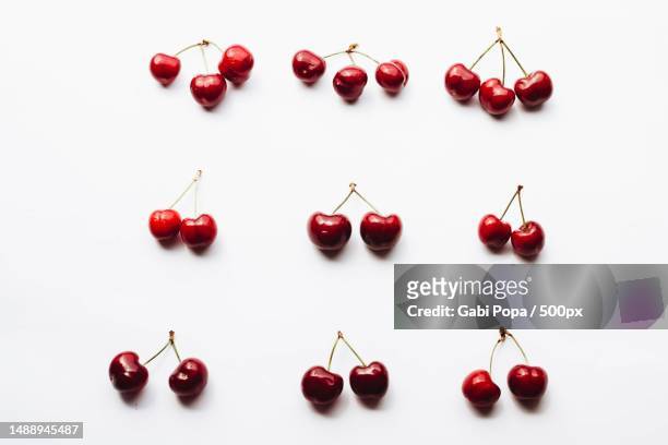 top view of cherries on white background,romania - cherry on top stock-fotos und bilder