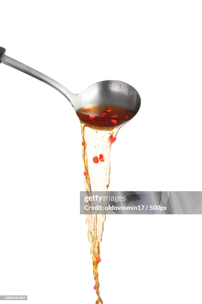 Dipper pouring spicy noodle soup on white background,Soup for sukiyaki from chicken and fish,Romania