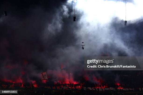 Milan fans light flares during the UEFA Champions League semi-final first leg match between AC Milan and FC Internazionale at San Siro on May 10,...