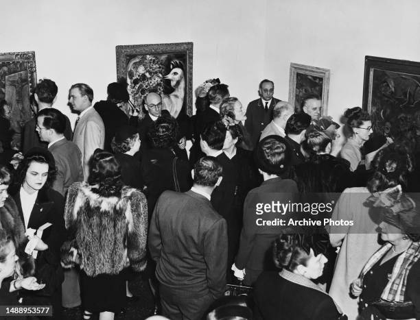 Guests attend a private view for the Marc Chagall exhibition held at the Museum of Modern Art, New York City, circa 1946.