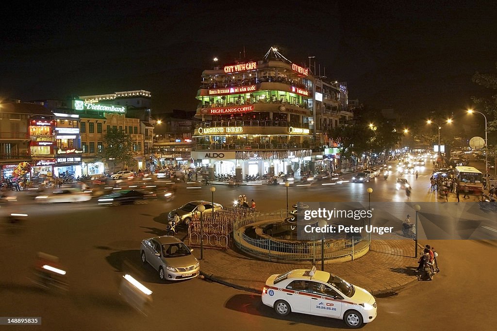 Busy intersection at night in old quarter.