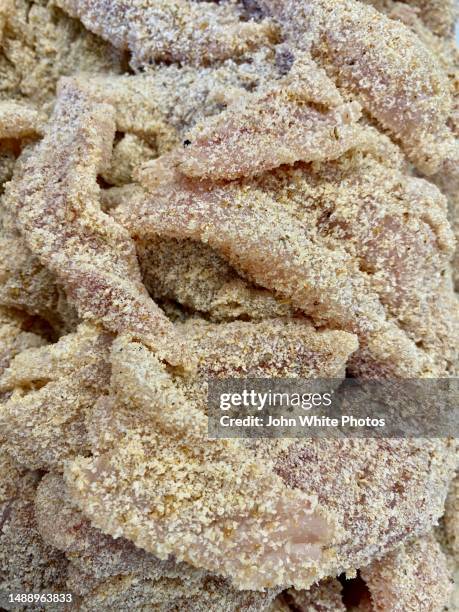 fish fillets crumbed ready to be cooked. - crumbed fish stockfoto's en -beelden