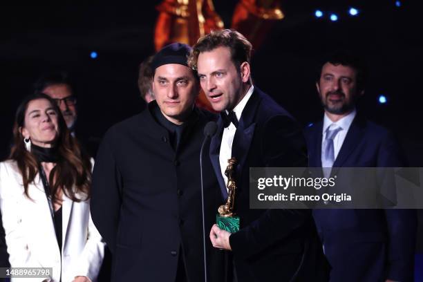 Luca Marinelli and Alessandro Borghi speak on stage as Charlotte Vandermeersch and Felix van Groeningen receive the David di Donatello for David di...