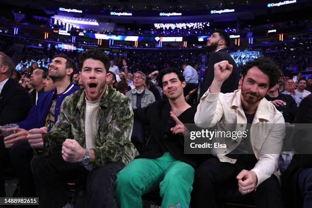 Nick Jonas, Joe Jonas and Kevin Jonas of the Pop band The Jonas Brothers attend game five of the Eastern Conference Semifinals in the 2023 NBA...