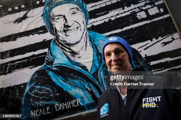 Neale Daniher - FightMND Patron stands in front of a portrait painted by artist Vincent Fantauzzo on May 11, 2023 in Melbourne, Australia.