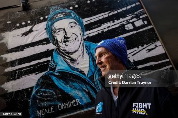 Neale Daniher - FightMND Patron stands in front of a portrait painted by artist Vincent Fantauzzo on May 11, 2023 in Melbourne, Australia.