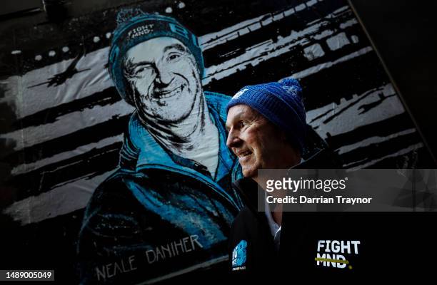 Neale Daniher - FightMND Patron stands in front of a portrait painted by artist Vincent Fantauzzo on May 11, 2023 in Melbourne, Australia.