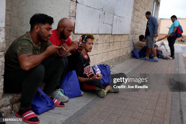 Greg Marcano, Ronald Tovar and Jefferson Bonilla, who are from Venezuela and heading to Dallas, Chicago and Atlanta respectively, wait for a bus...