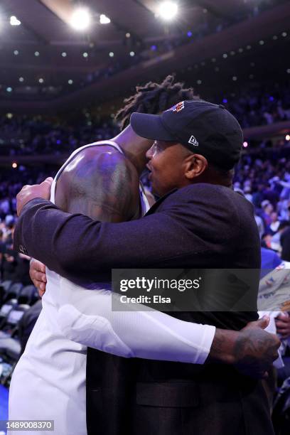 Julius Randle of the New York Knicks celebrates with former New York Knicks John Starks after defeating the Miami Heat during in game five of the...