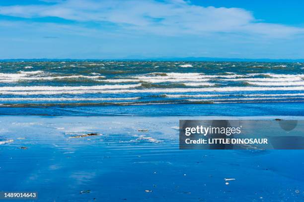 the rippling sea, the blue sky, and the reflective sandy beach. ise, mie japan - ise mie stock pictures, royalty-free photos & images