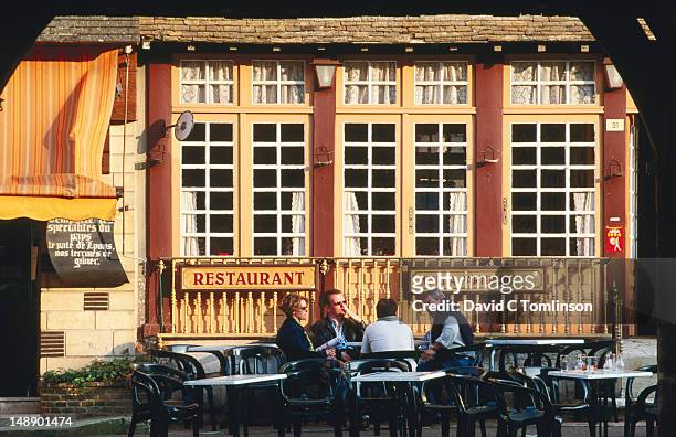 people chatting outside restaurant in main square, late afternoon, lyons-la-foret, eure. - lyons la forêt photos et images de collection
