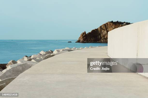 sidewalk by the sea - groyne stock-fotos und bilder