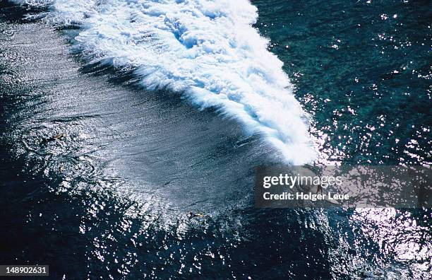 aerial of surfer on giant wave. - western division fiji stock pictures, royalty-free photos & images