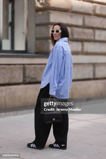 Elise Seitz seen wearing Soho Studios blue striped blouse, Hey Soho black wide pants, Zara white shades, Adidas samba black and white sneaker and a...