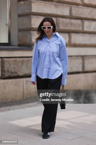 Elise Seitz seen wearing Soho Studios blue striped blouse, Hey Soho black wide pants, Zara white shades, Adidas samba black and white sneaker and a...