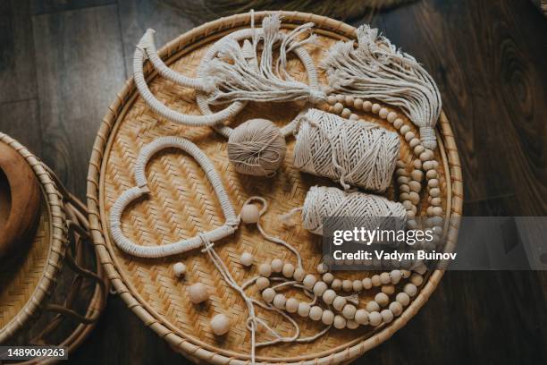 top view of macrame heart shape decor and cotton threads on the wicker table - wicker heart stock pictures, royalty-free photos & images