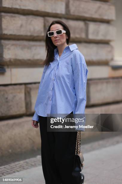 Elise Seitz seen wearing Soho Studios blue striped blouse, Hey Soho black wide pants, Zara white shades, Adidas samba black and white sneaker and a...