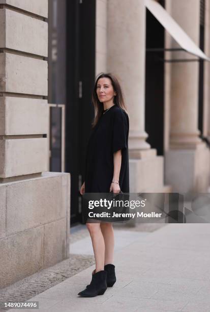 Elise Seitz seen wearing Hey Soho black shirt dress, Celine white shades, Isabel Marant black boots, Bottega Veneta mini Jodie black bag on May 09,...