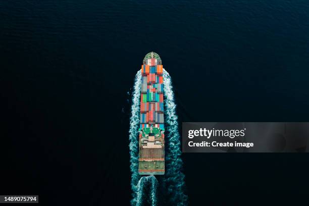 aerial top view container cargo ship full speed with wonderful wave pattern carrier container on the sea for business logistics, import export shipping or freight transportation. - full elevator stock pictures, royalty-free photos & images